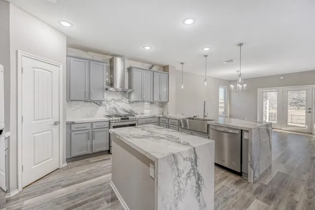 a kitchen with a sink stove and cabinets