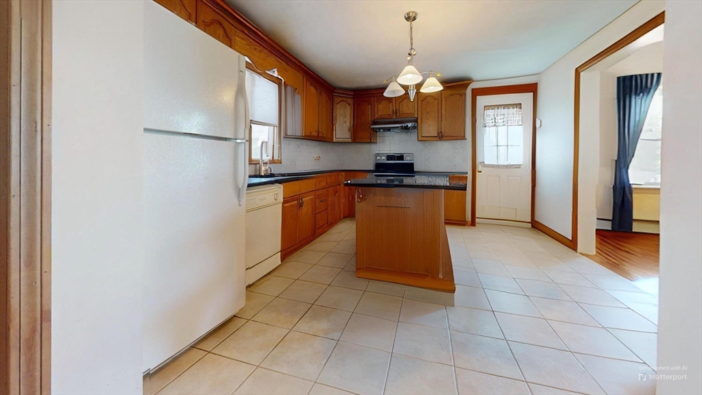 118 Colby Road Quincy, MA 02171 - Photo 17 of 40 a kitchen with stainless steel appliances granite countertop a refrigerator and a stove