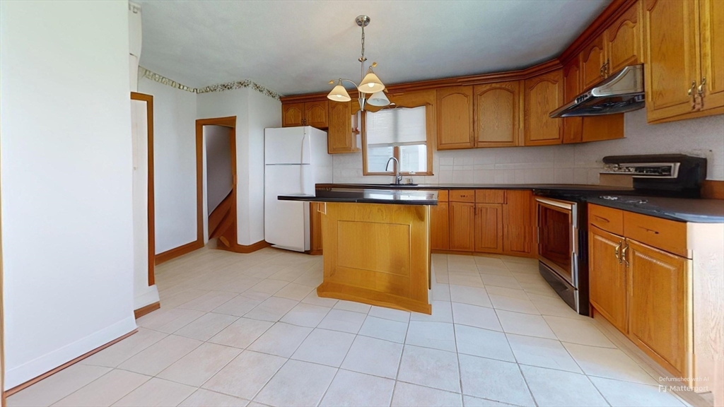 118 Colby Road Quincy, MA 02171 - Photo 18 of 40 a kitchen with stainless steel appliances granite countertop a sink a stove and a refrigerator
