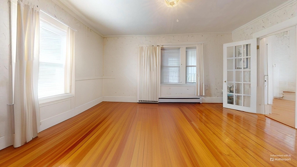 118 Colby Road Quincy, MA 02171 - Photo 21 of 40 an empty room with wooden floor and windows