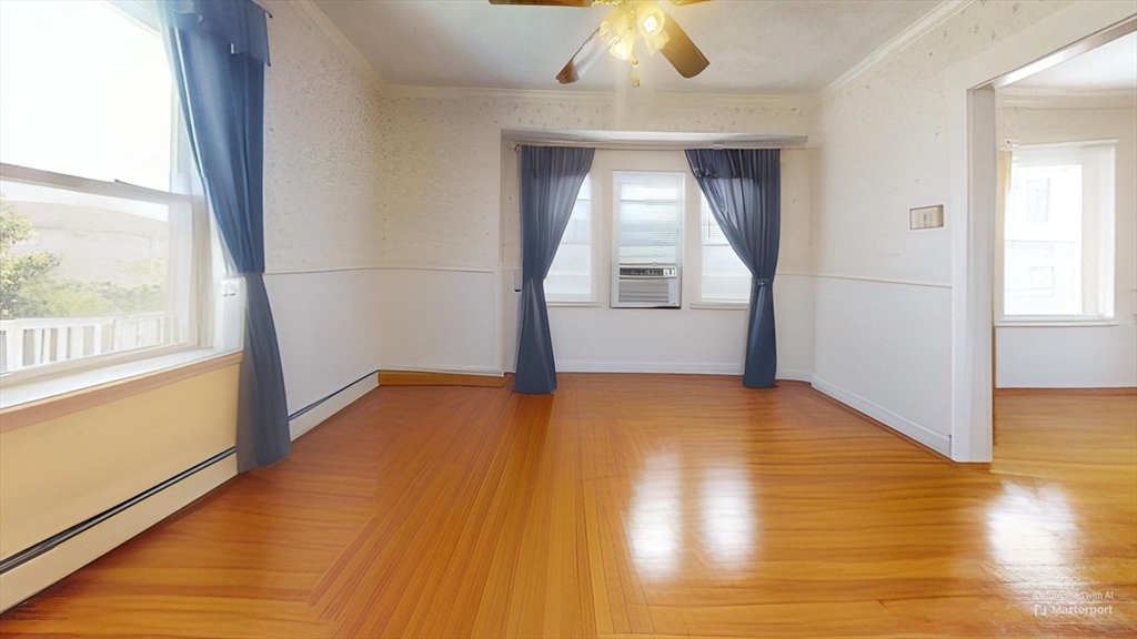 118 Colby Road Quincy, MA 02171 - Photo 22 of 40 a view of empty room with wooden floor and fan