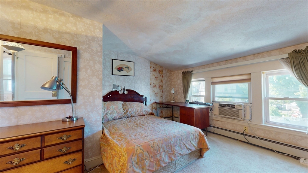 118 Colby Road Quincy, MA 02171 - Photo 25 of 40 a bedroom with a bed and a dresser next to a window