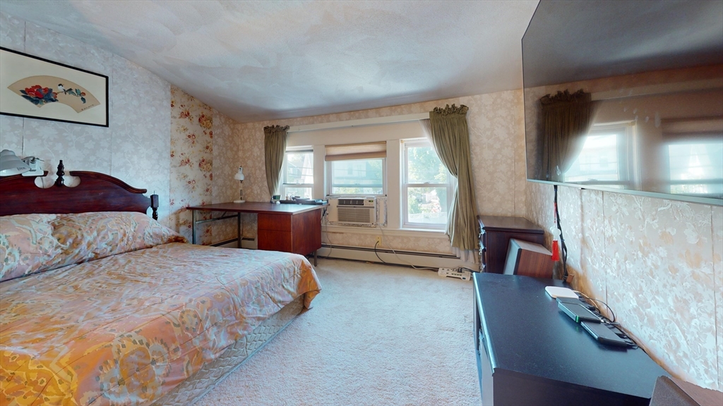 118 Colby Road Quincy, MA 02171 - Photo 26 of 40 a bedroom with a bed and a couch next to a window
