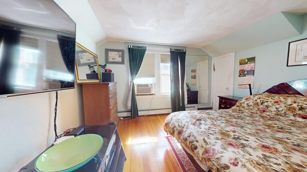 118 Colby Road Quincy, MA 02171 - Photo 28 of 40 a bedroom with a bed dresser and a mirror