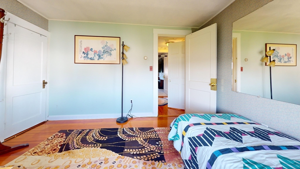 118 Colby Road Quincy, MA 02171 - Photo 30 of 40 a bedroom with a bed and a painting on the wall