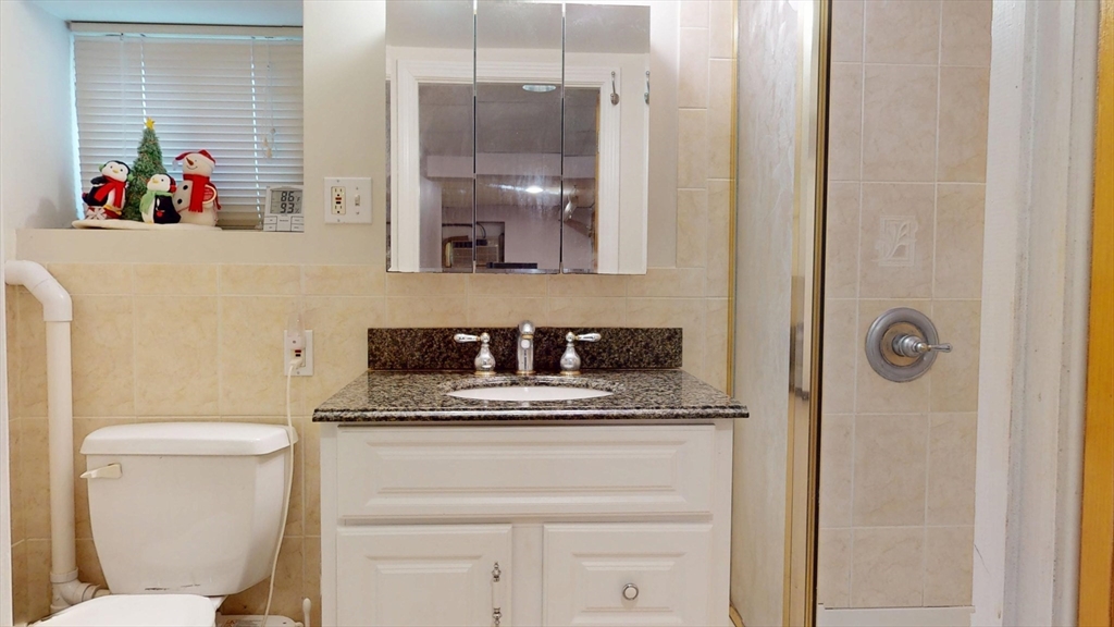 118 Colby Road Quincy, MA 02171 - Photo 36 of 40 a bathroom with a sink a toilet and a mirror