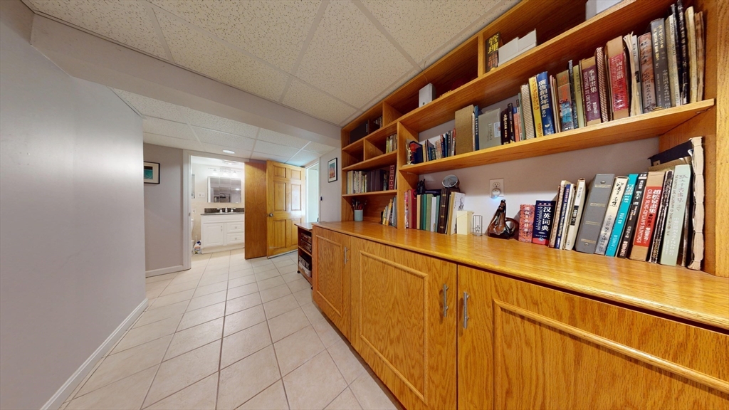 118 Colby Road Quincy, MA 02171 - Photo 38 of 40 a hallway with a large shelf with books