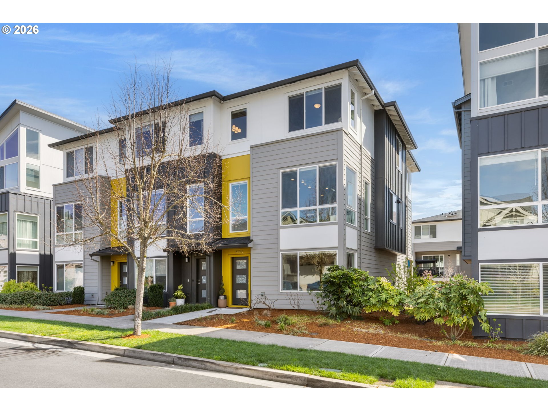 17312 Southwest Kite Lane Beaverton, OR 97007 - Photo 1 of 37 a front view of a residential apartment building with a yard
