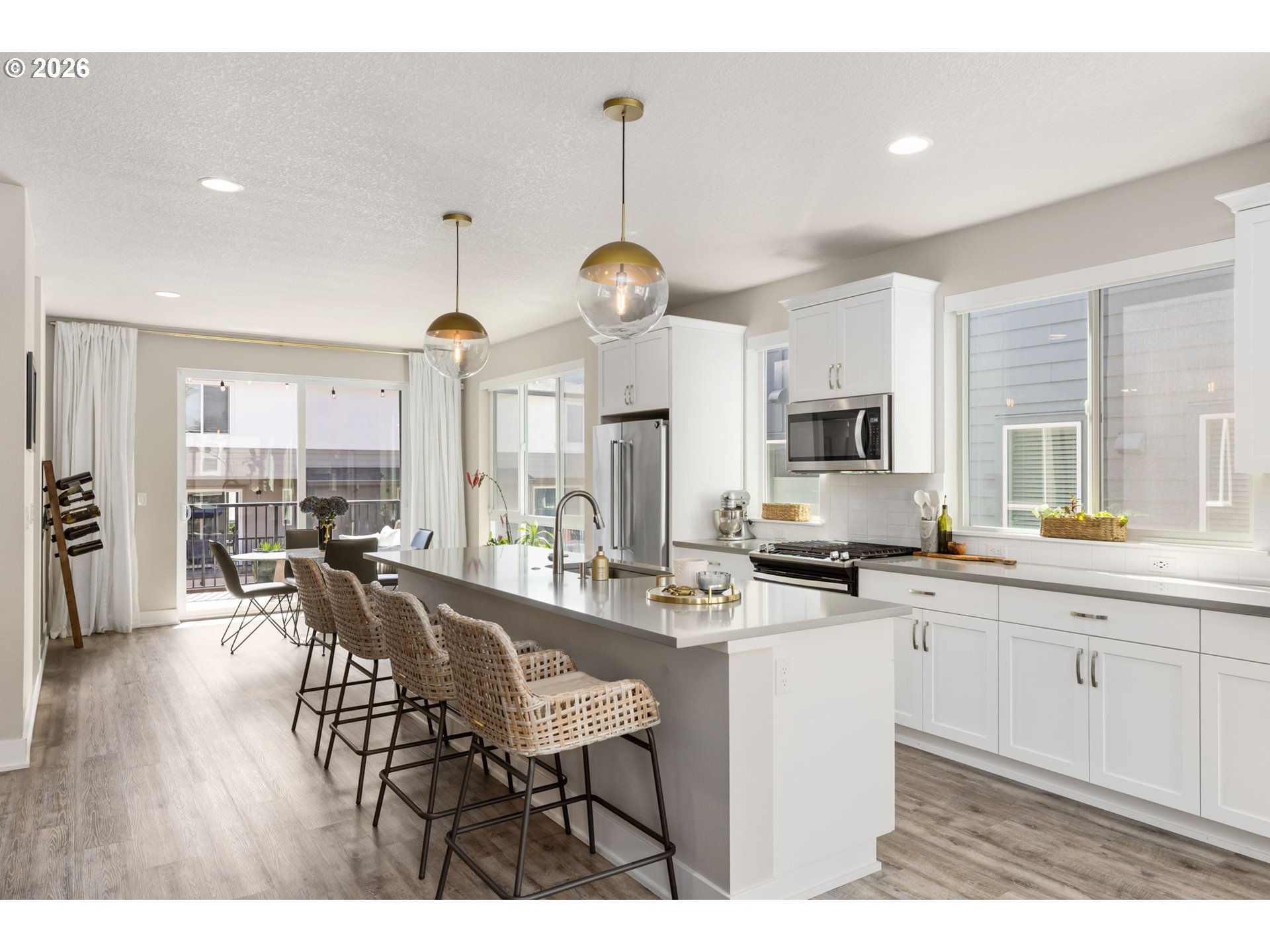 17312 Southwest Kite Lane Beaverton, OR 97007 - Photo 11 of 37 a kitchen with stainless steel appliances kitchen island granite countertop a sink cabinets and wooden floor