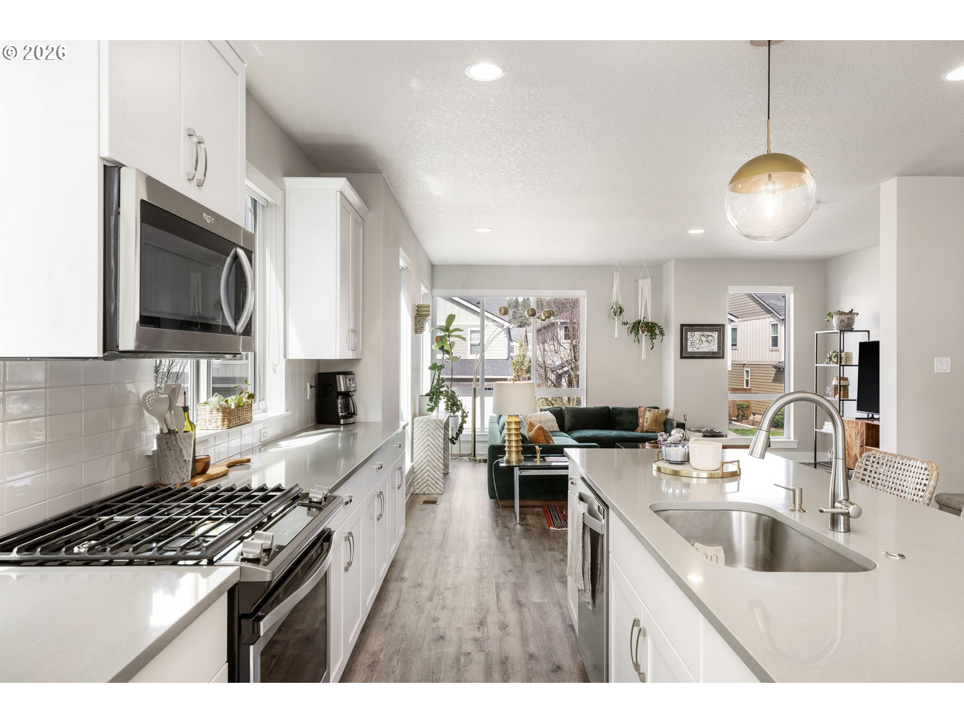 17312 Southwest Kite Lane Beaverton, OR 97007 - Photo 12 of 37 a kitchen with stainless steel appliances a stove a sink a oven a dining table and chairs