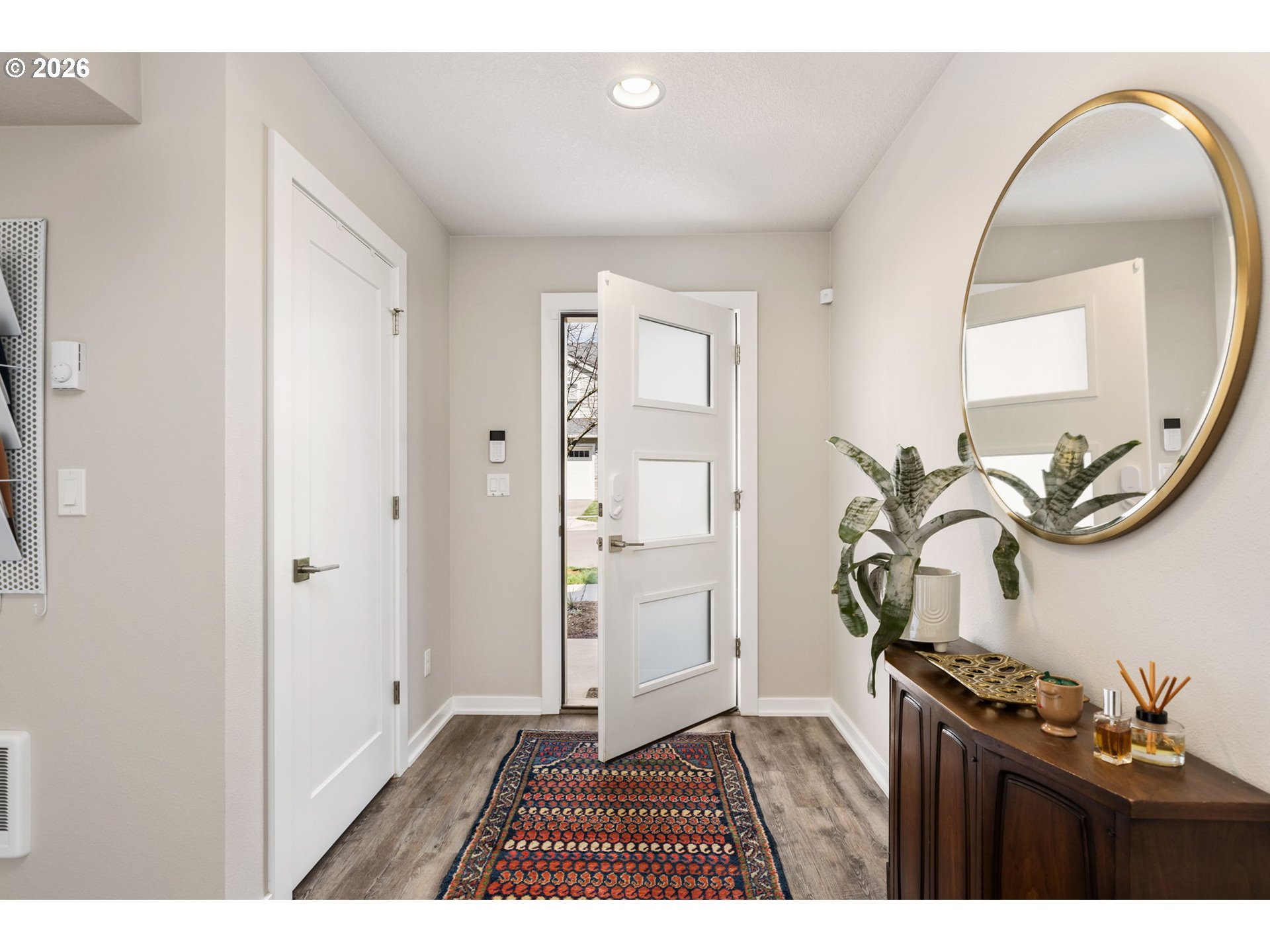 17312 Southwest Kite Lane Beaverton, OR 97007 - Photo 3 of 37 a living room with a mirror and a potted plant
