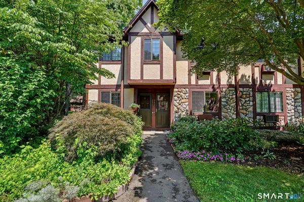 a front view of a house with garden