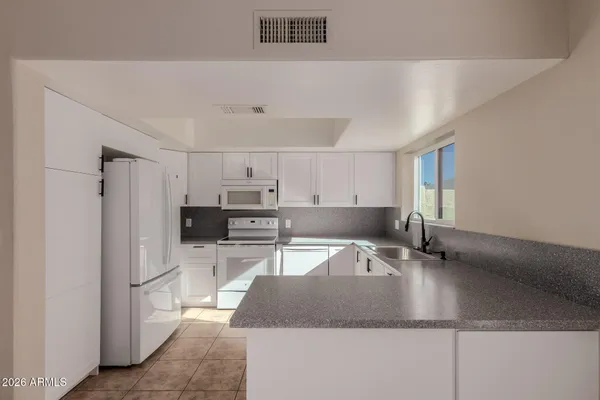 a view of a kitchen with a sink and a fireplace