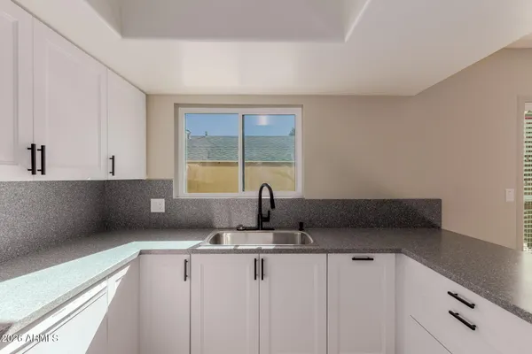 a view of a kitchen with electric appliances