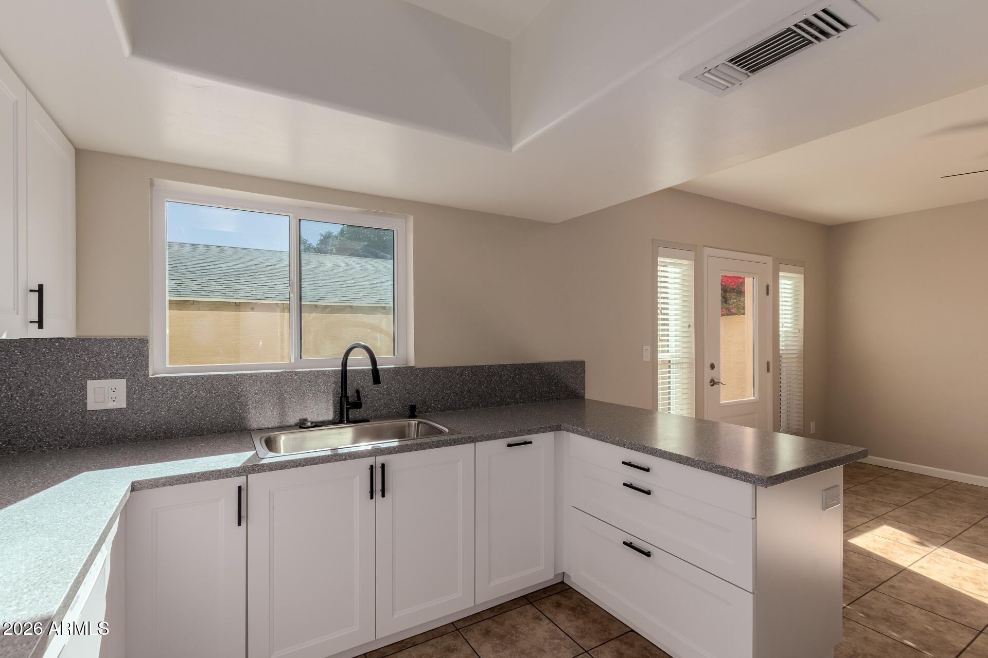 6223 North 12th Street, Unit 2 Phoenix, AZ 85014 - Photo 12 of 38 a kitchen with granite countertop a sink and white cabinets
