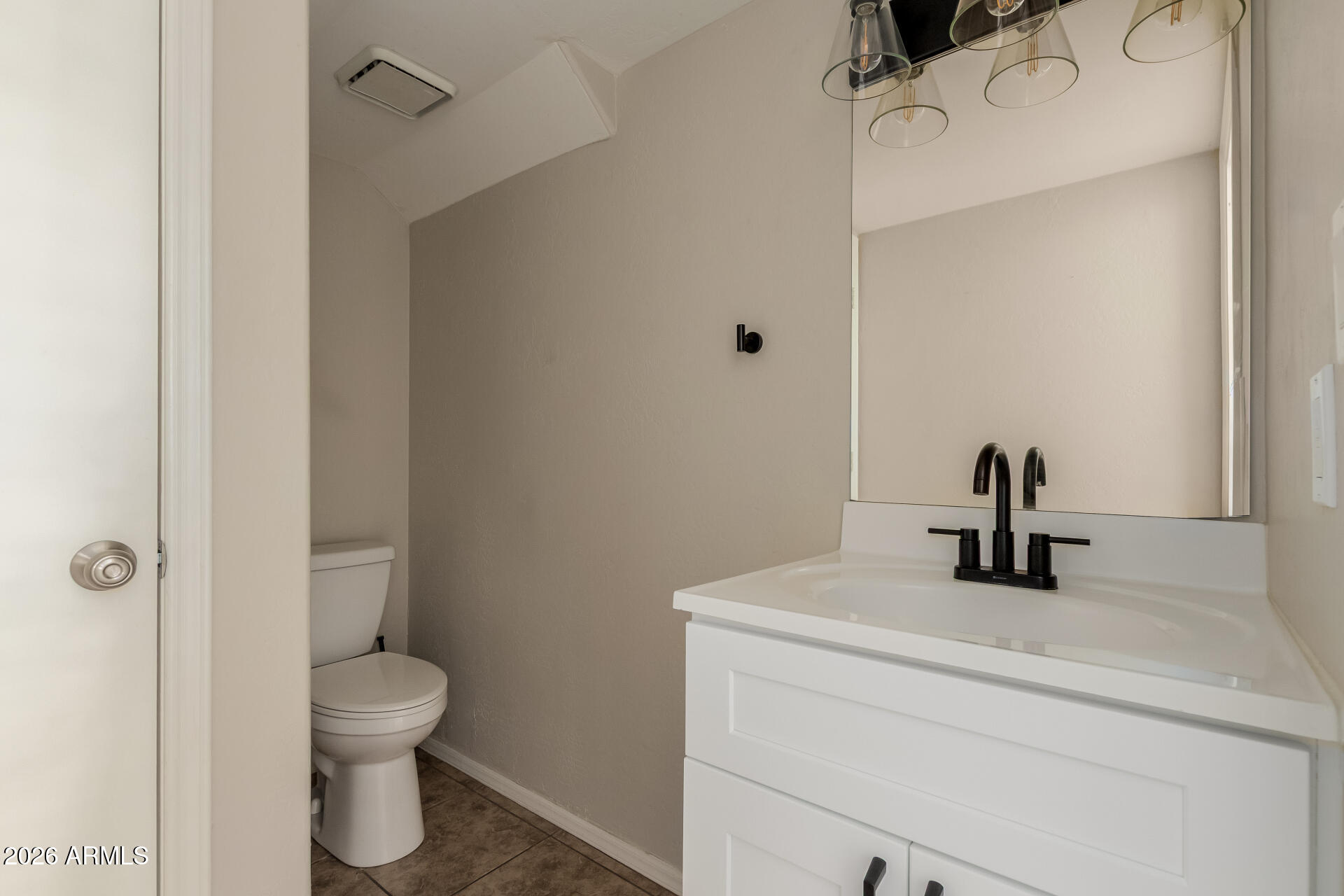 6223 North 12th Street, Unit 2 Phoenix, AZ 85014 - Photo 13 of 38 a bathroom with a toilet sink and a mirror
