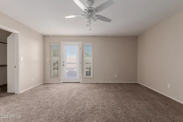 a kitchen with granite countertop a sink and white cabinets