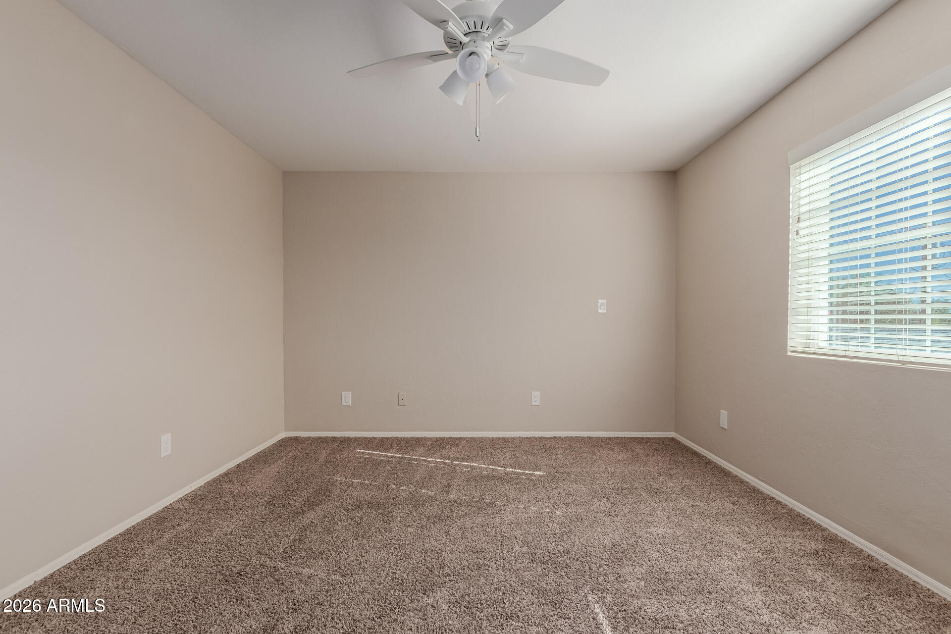6223 North 12th Street, Unit 2 Phoenix, AZ 85014 - Photo 22 of 38 an empty room with a window and a fan