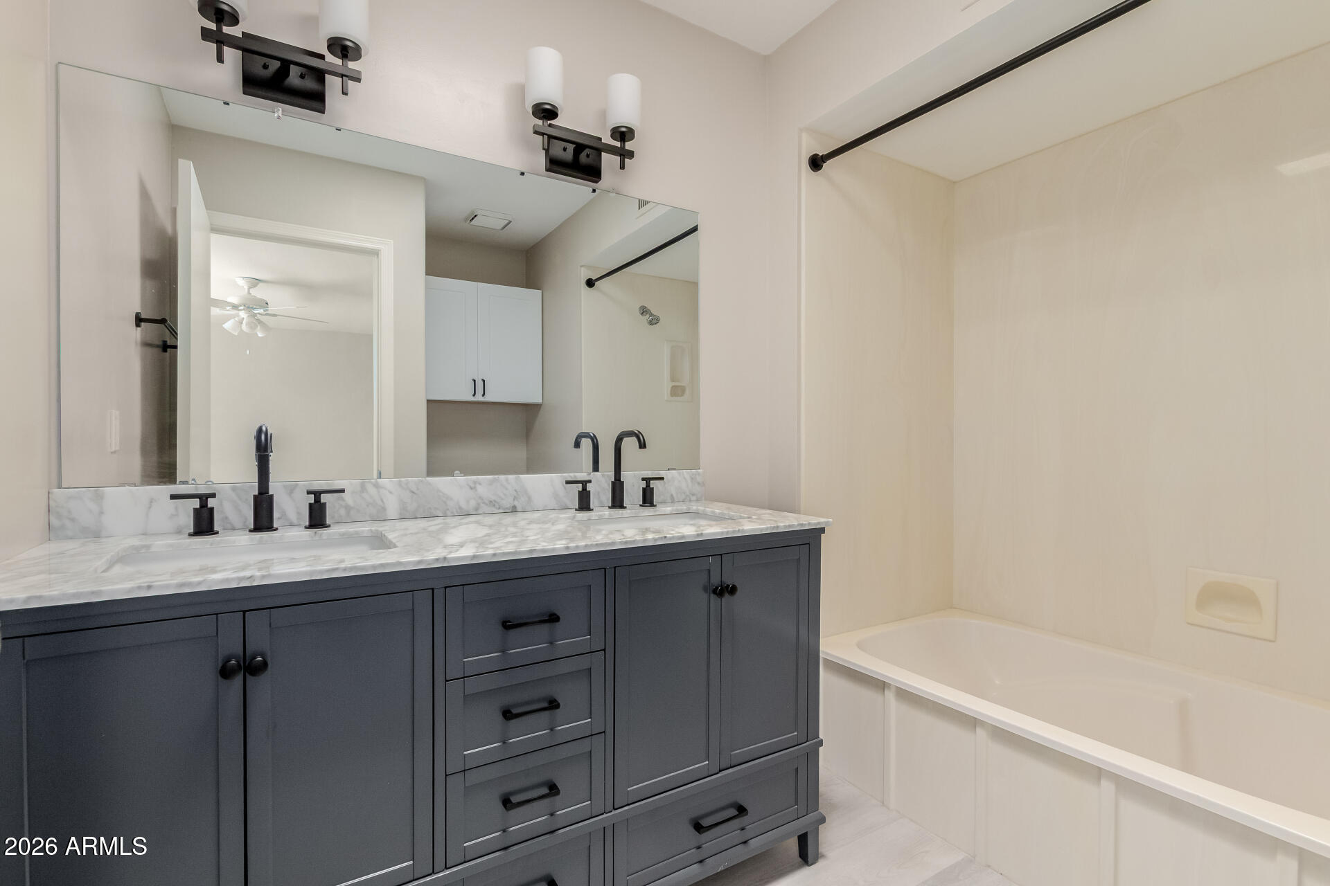 6223 North 12th Street, Unit 2 Phoenix, AZ 85014 - Photo 23 of 38 a bathroom with a granite countertop sink mirror bathtub and shower
