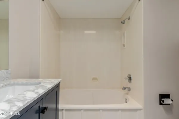 an empty room with closet and a ceiling fan