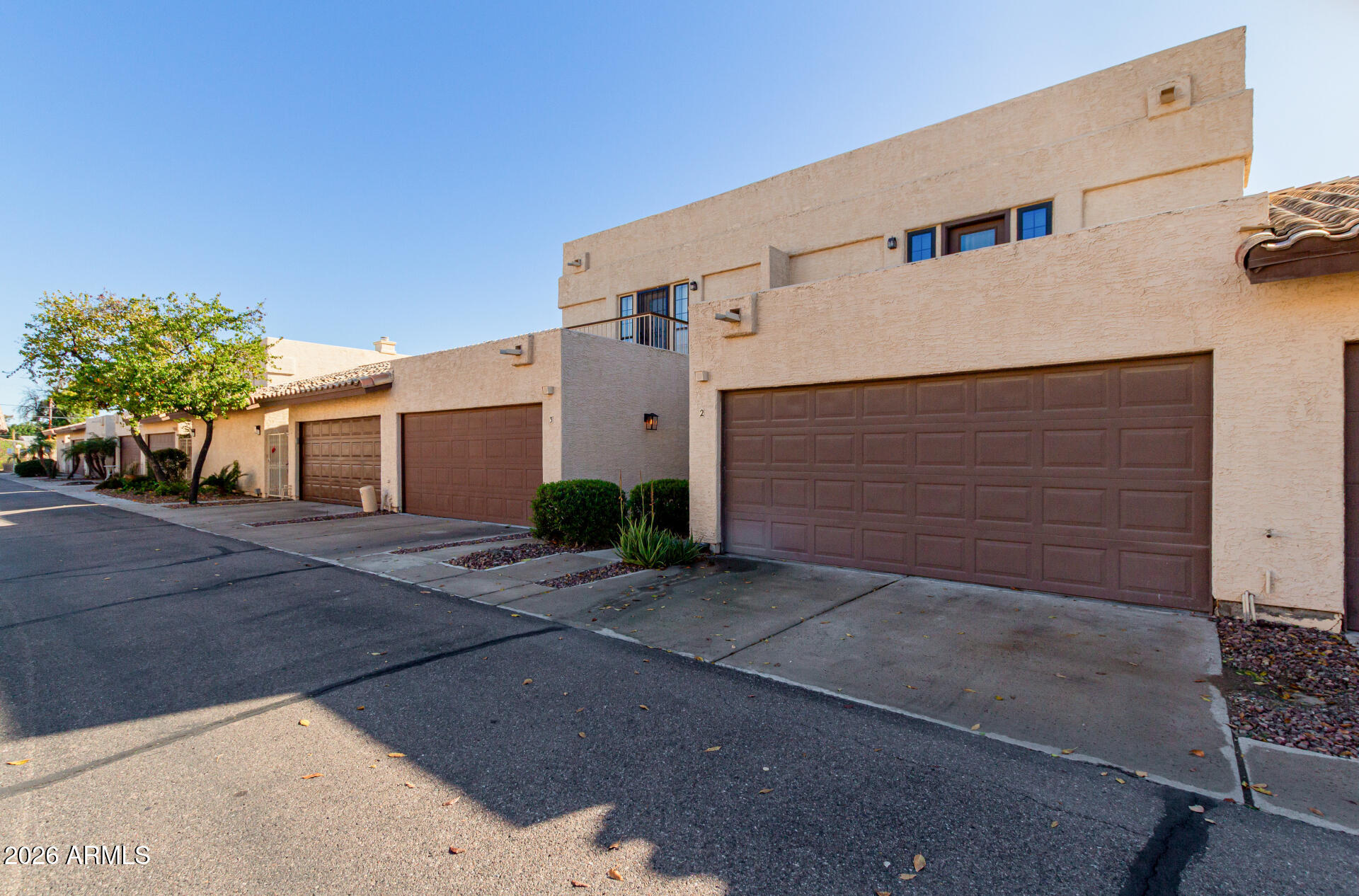 6223 North 12th Street, Unit 2 Phoenix, AZ 85014 - Photo 2 of 38 a front view of a house with a yard and garage
