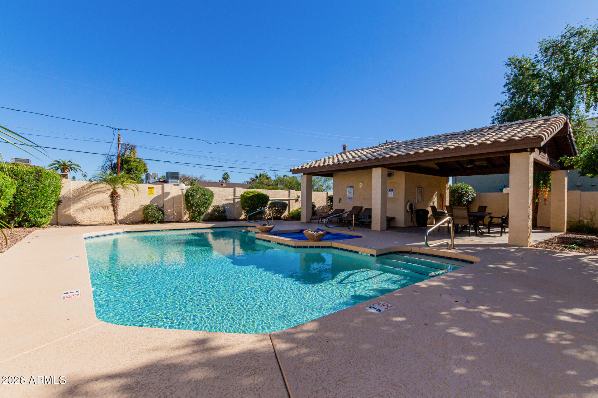 6223 North 12th Street, Unit 2 Phoenix, AZ 85014 - Photo 32 of 38 a view of a swimming pool and lounge chairs