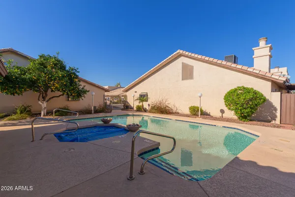 a view of a swimming pool and lounge chairs