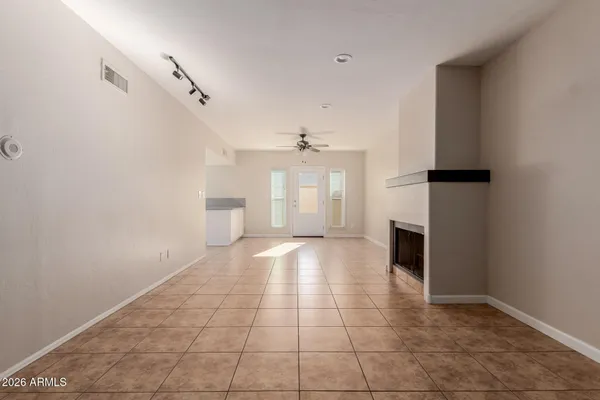 a view of an empty room with a fireplace