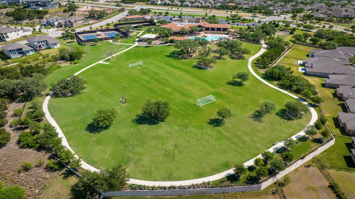 1217 Novara Trail Leander, TX 78641 - Photo 33 of 40 an aerial view of a residential houses with outdoor space and swimming pool