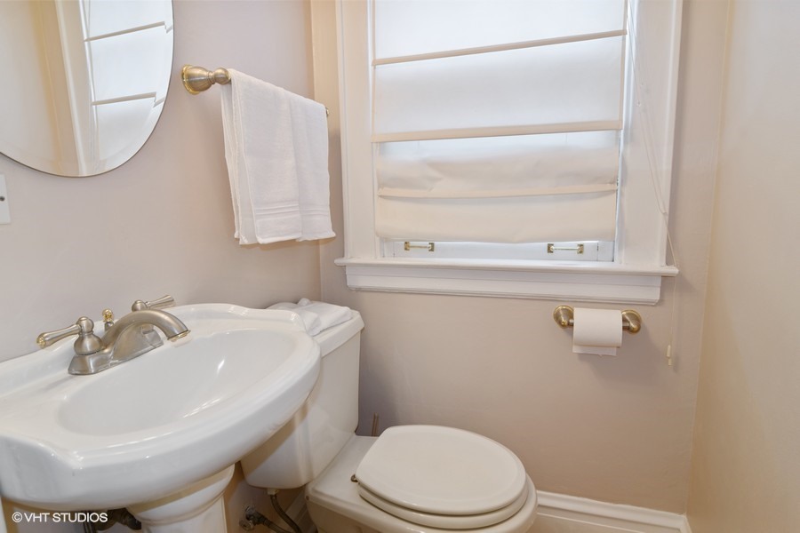 324 Blackhawk Road Riverside, IL 60546 - Photo 14 of 16 a bathroom with a sink a toilet and mirror