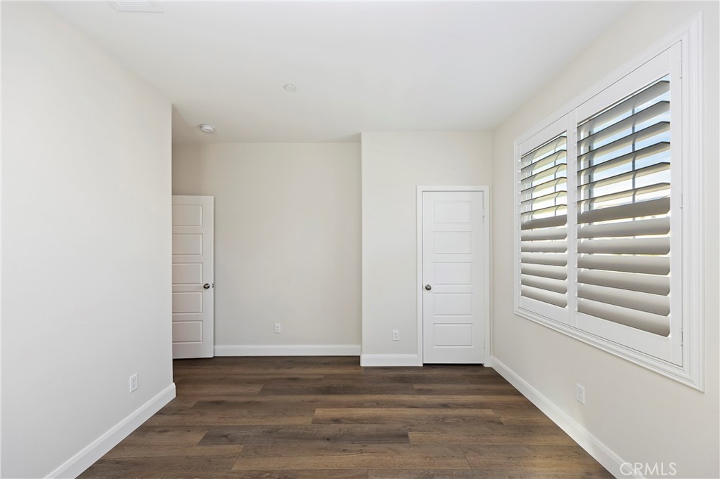 34709 Candlestick Circle Murrieta, CA 92563 - Photo 23 of 40 a view of an empty room with a window and wooden floor