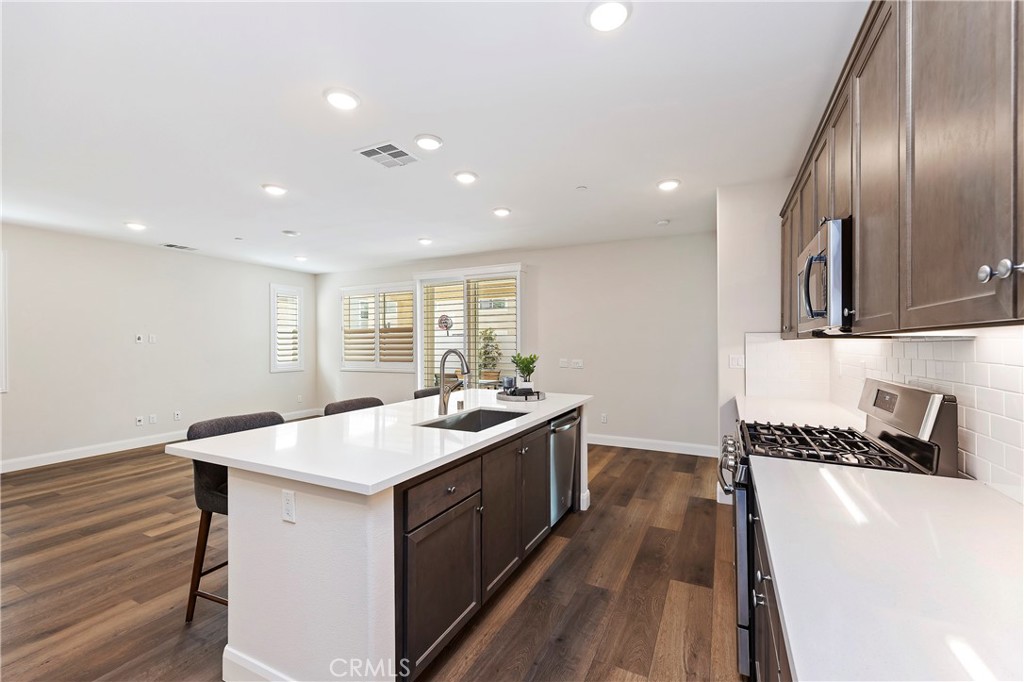 34709 Candlestick Circle Murrieta, CA 92563 - Photo 30 of 40 a kitchen with a sink stove and cabinets