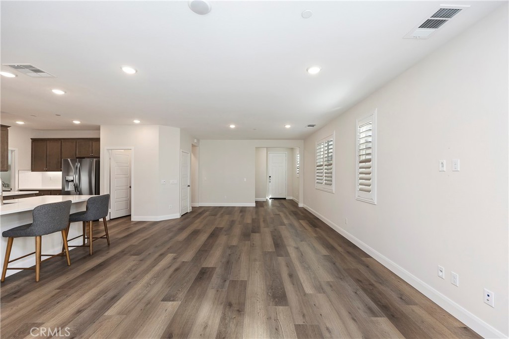 34709 Candlestick Circle Murrieta, CA 92563 - Photo 9 of 40 a view of a big room with wooden floor and a window