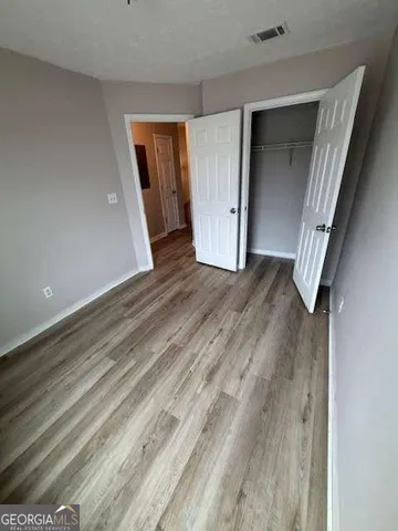 a view of a hallway with wooden floor