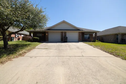 a front view of a house with yard