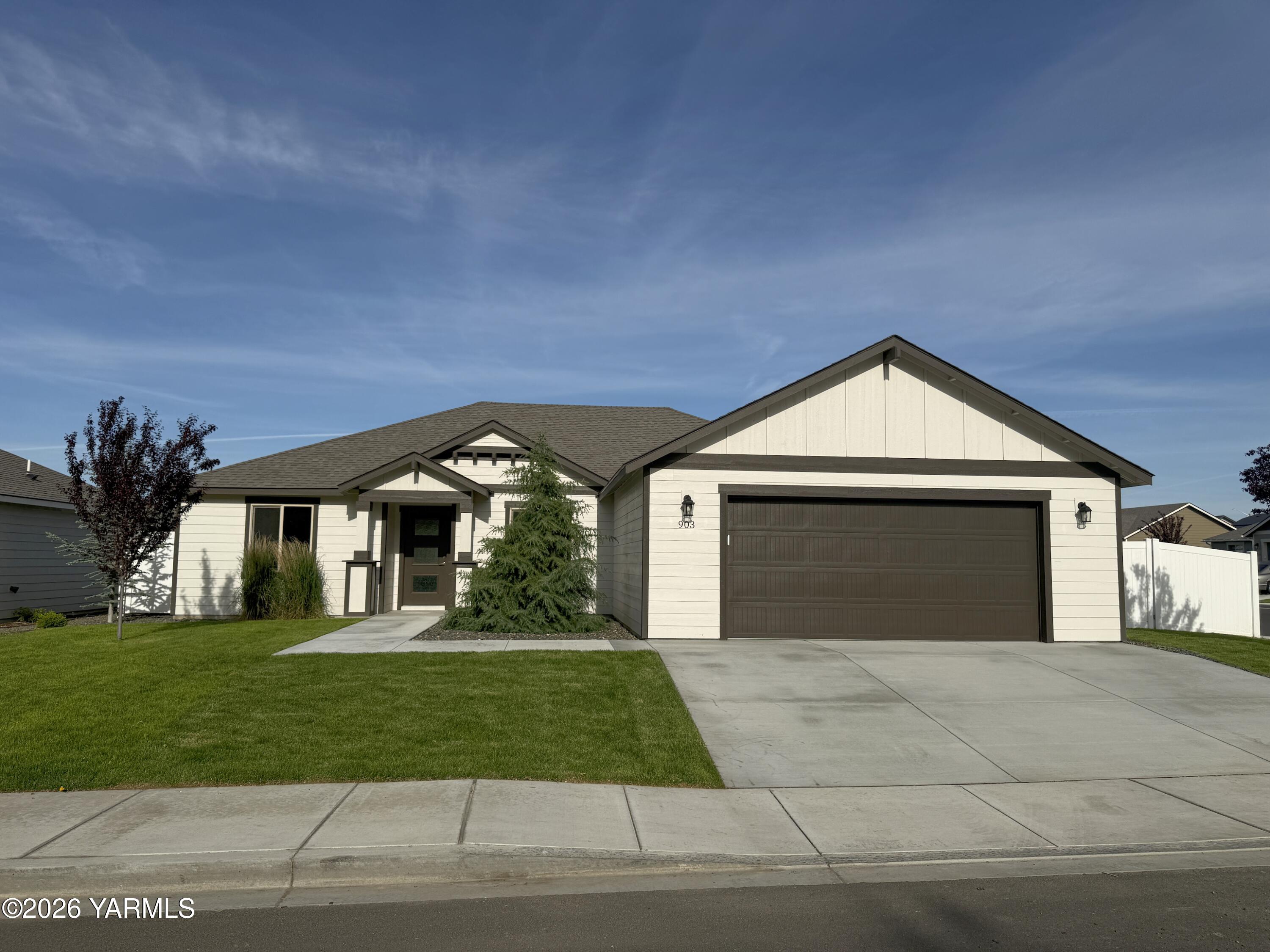 903 North Euclid Road, Unit PHASE 1 LOT 8) SPEC Grandview, WA 98930 - Photo 2 of 25 a front view of a house with a yard and garage