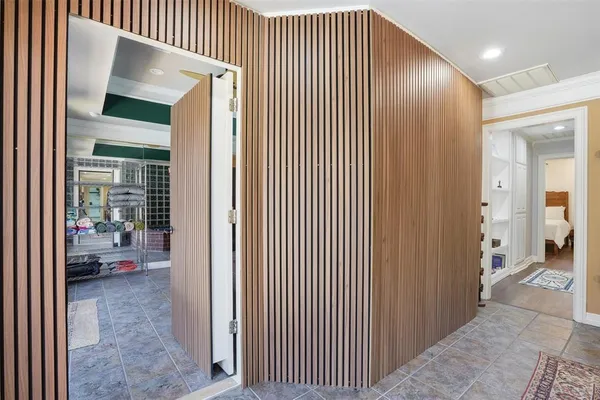 a view of a hallway with a livingroom and a dinning area with furniture