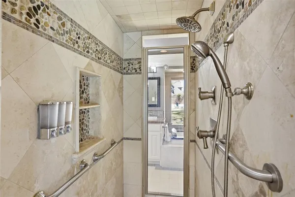a bathroom with a shower and a mirror