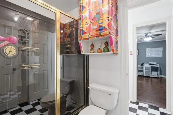 a bathroom with a toilet and shower