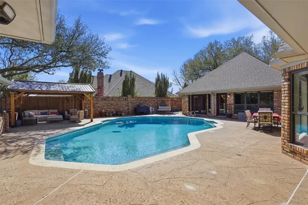 a view of a house with swimming pool and sitting area