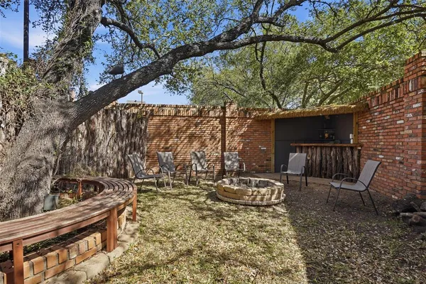 a backyard of a house with table and chairs
