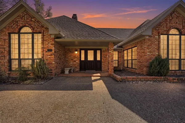 a view of a brick house with large windows