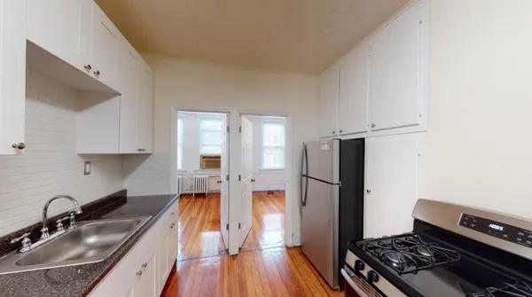 a kitchen with a sink stove and refrigerator