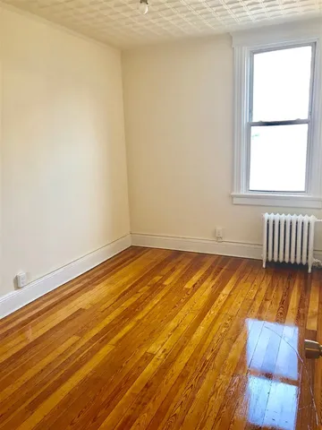 a view of a room with wooden floor and chair