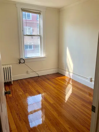 a room with a bed and wooden floor