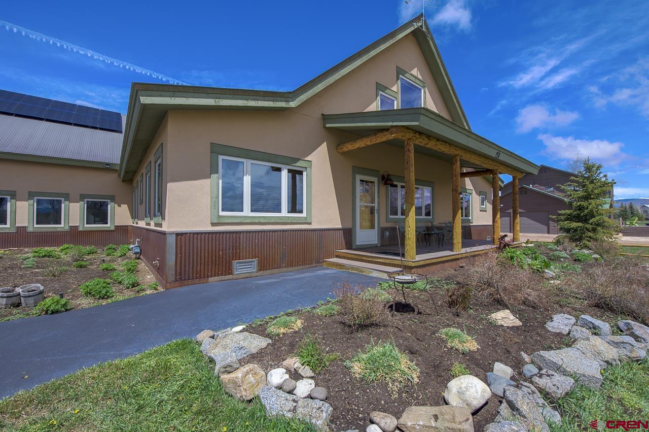 157 Spring Meadow Trail Gunnison, CO 81230 - Photo 12 of 43 a front view of a house with garden