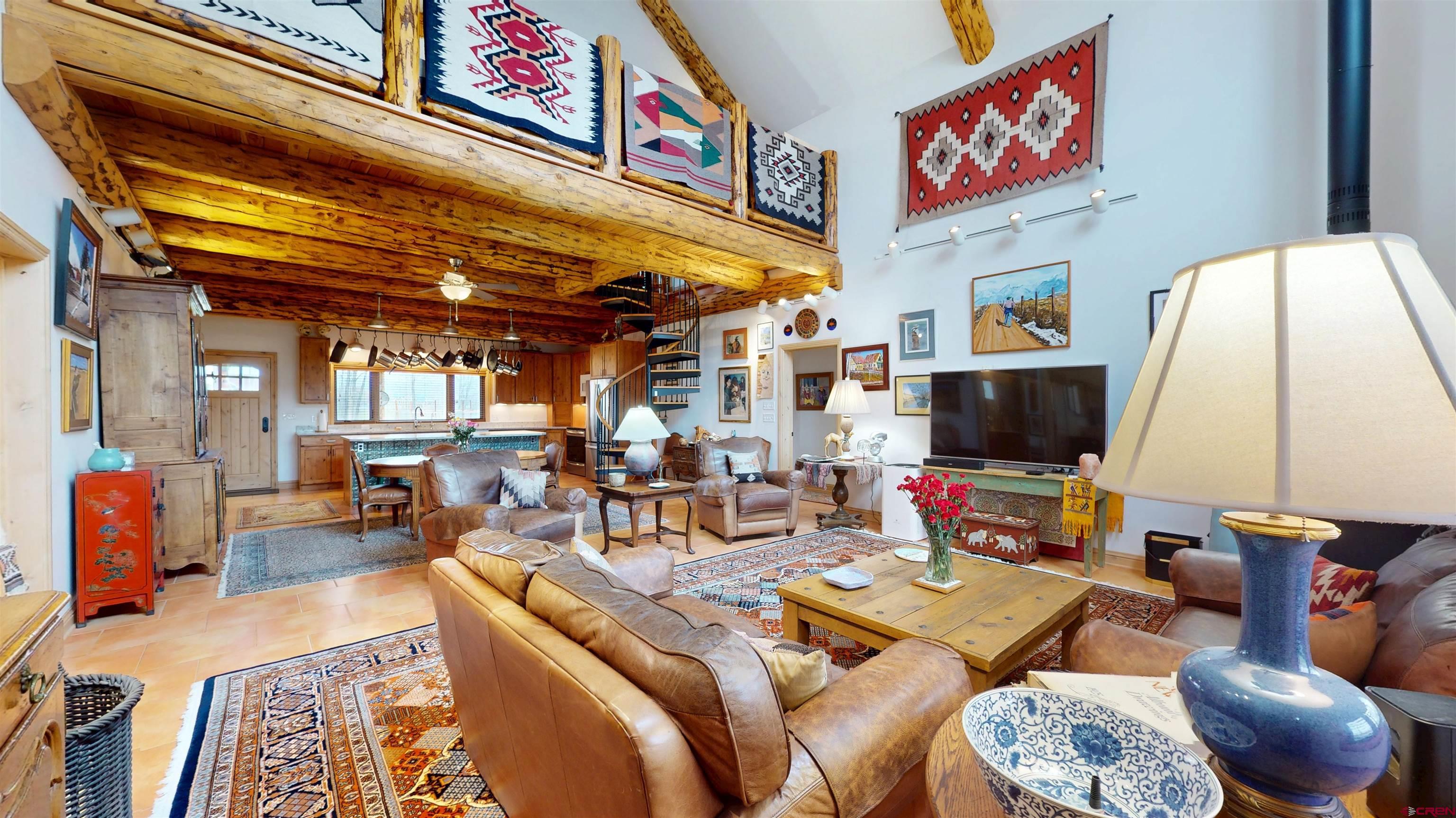 157 Spring Meadow Trail Gunnison, CO 81230 - Photo 16 of 43 a living room with furniture and a flat screen tv