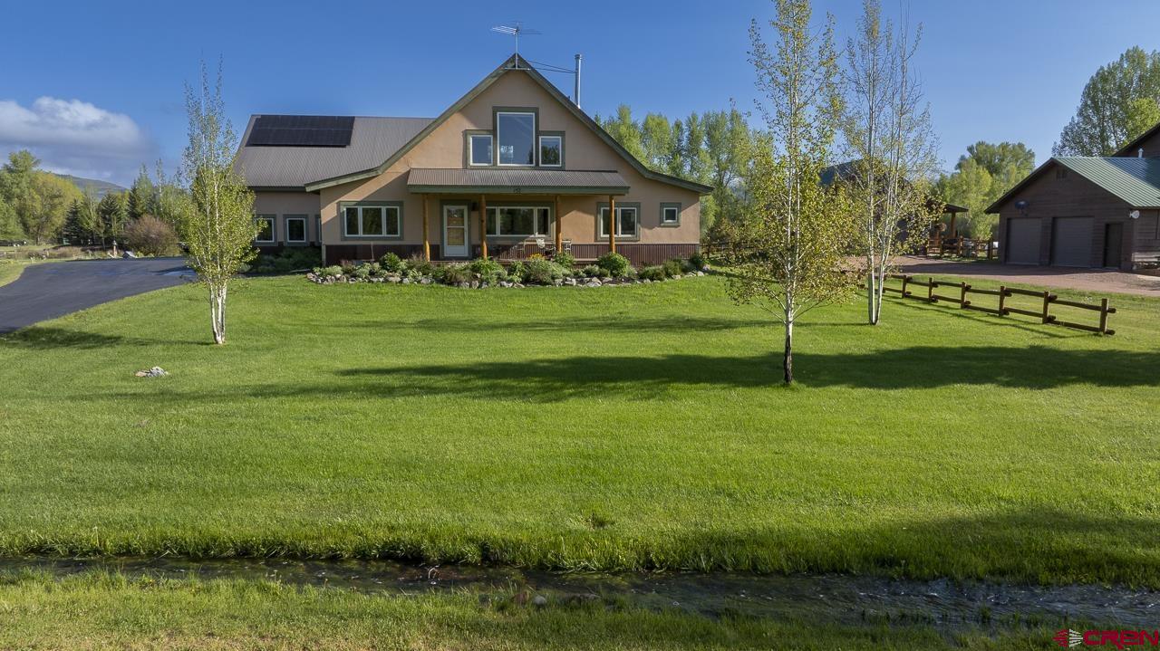 157 Spring Meadow Trail Gunnison, CO 81230 - Photo 2 of 43 a front view of a house with a yard