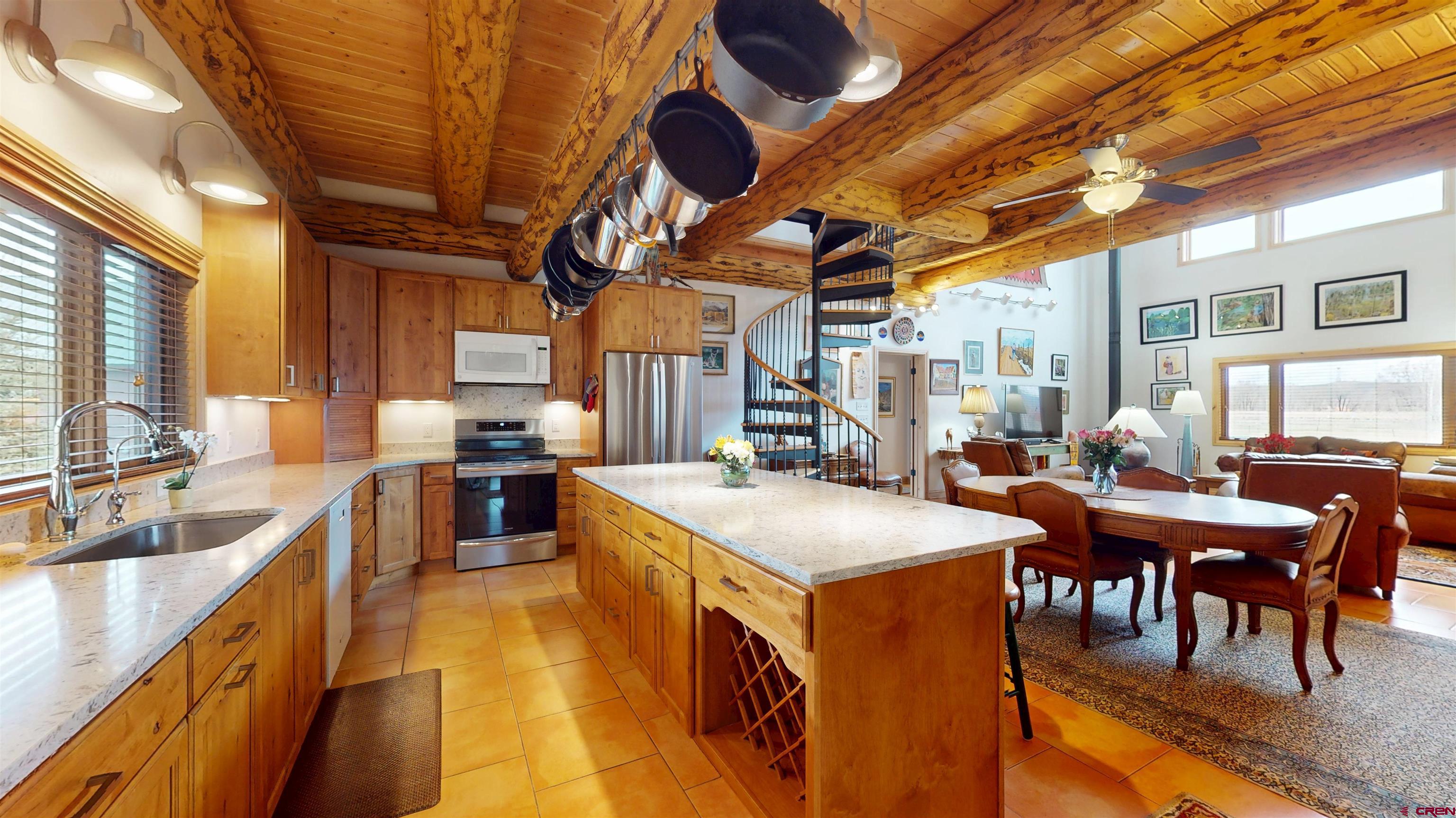 157 Spring Meadow Trail Gunnison, CO 81230 - Photo 21 of 43 Granite Counter tops,, Alder wood cabinets, new refrigerator 2024, induction cook stove 2022, tiled floors, Faux wood blinds. Reverse osmosis filter in the kitchen for drinking water.