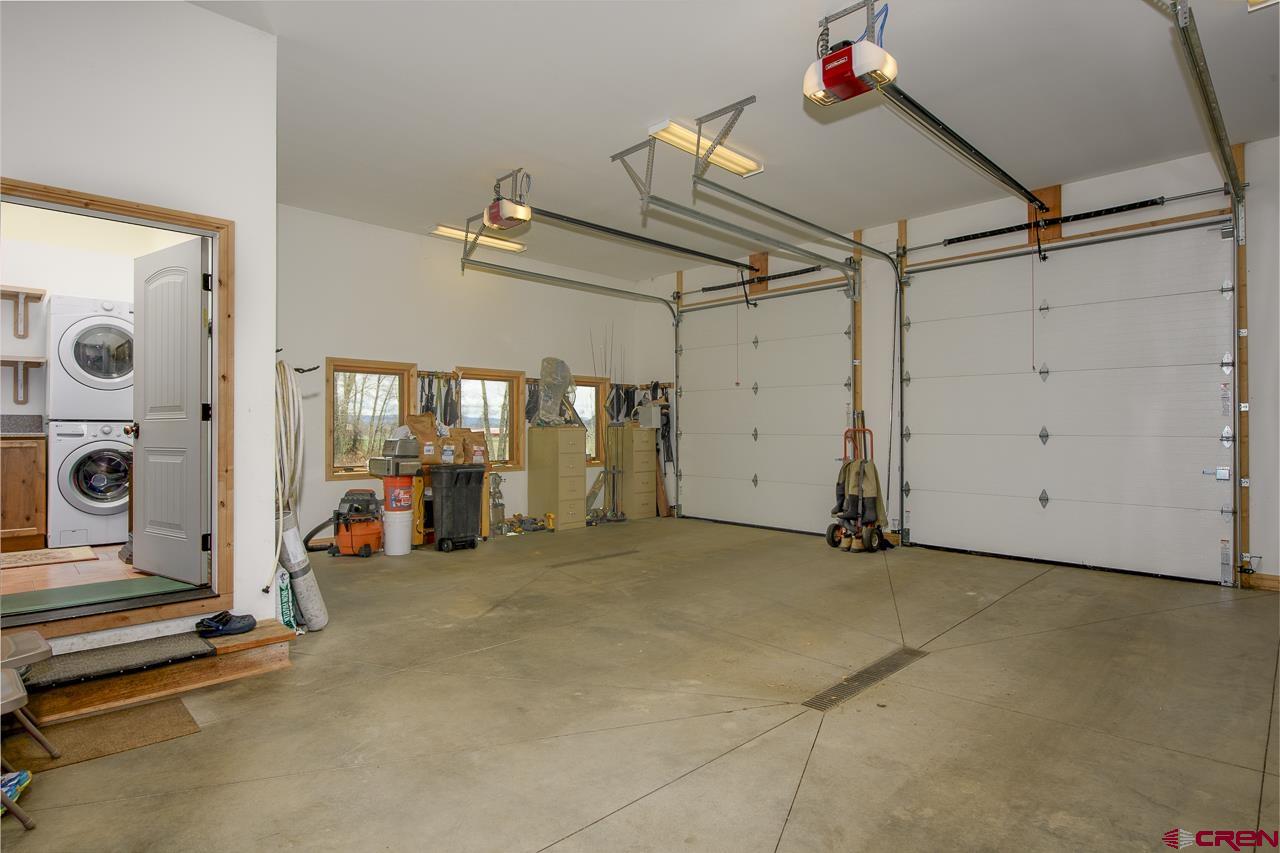 157 Spring Meadow Trail Gunnison, CO 81230 - Photo 25 of 43 Heated garage, floor drains, 3 oversized bays. Hot and cold water faucet. 30 Amp plug for the RV , 240 watt plug for kiln in garage workroom area with vent. Plug available to add 2 EV chargers.